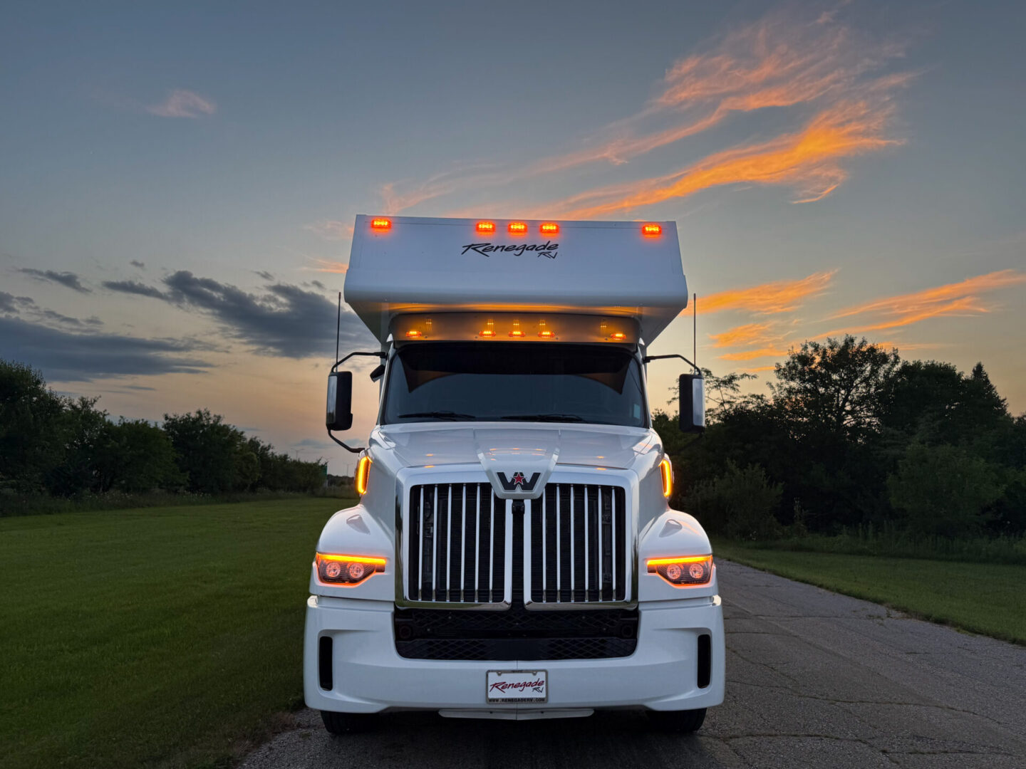 White truck with sunset background.