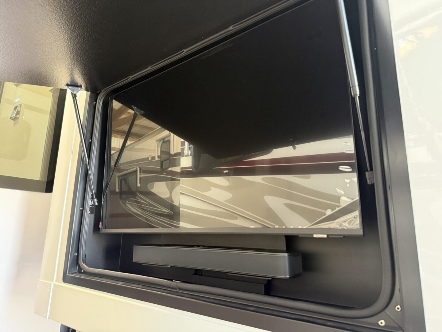 Retractable TV mounted in a cabinet.