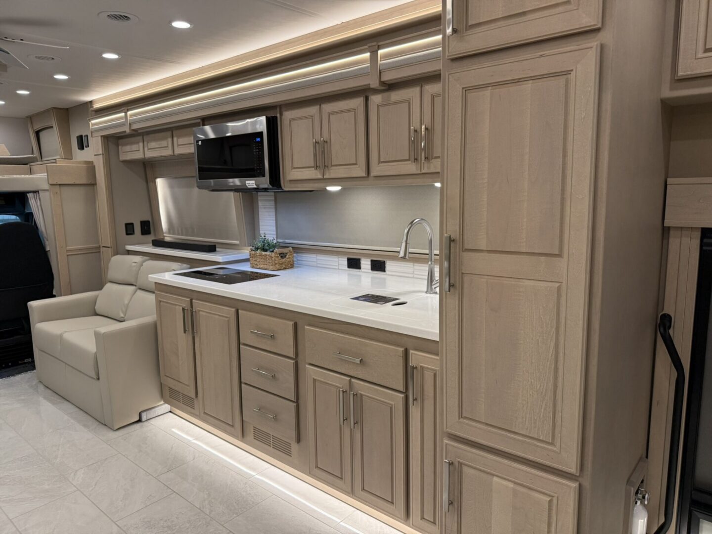 Modern kitchen interior with light wood cabinetry.