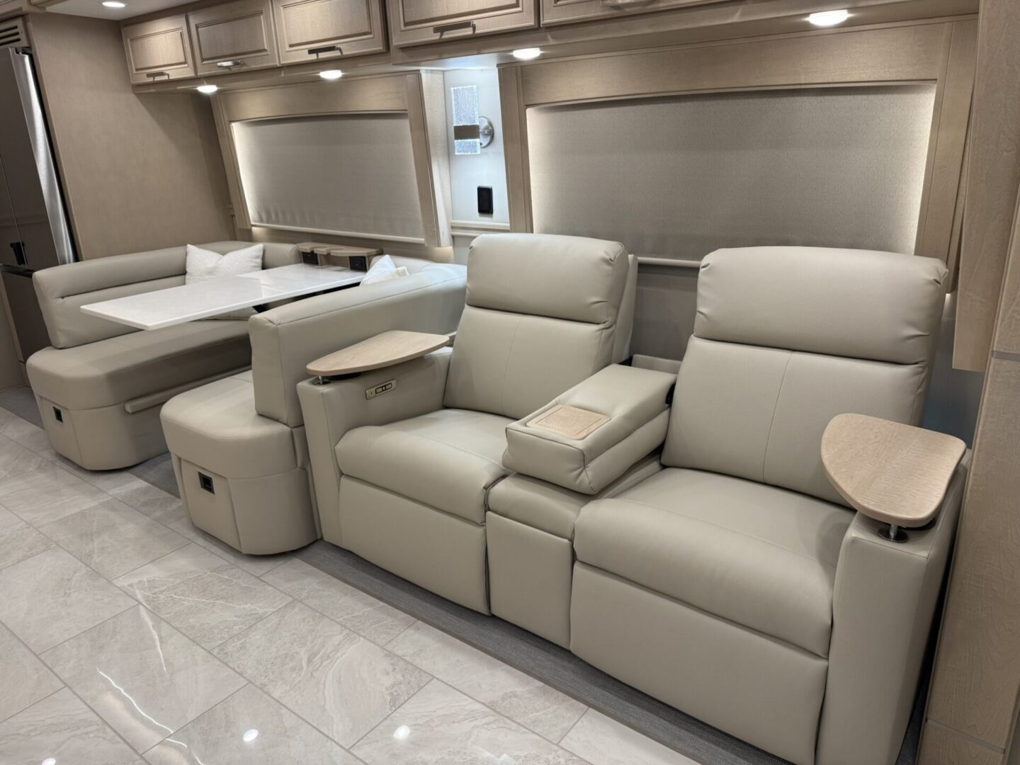 Modern beige reclining chairs in stylish interior.