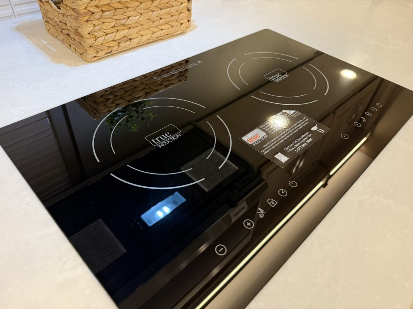 Black induction cooktop on a countertop.