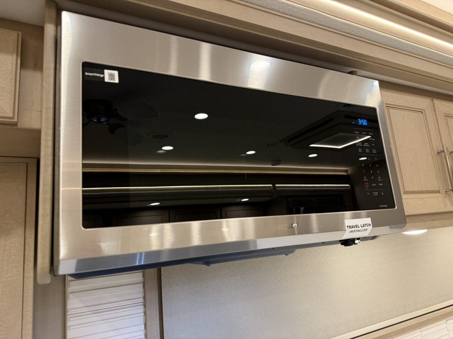 Stainless steel microwave oven mounted above cabinets.