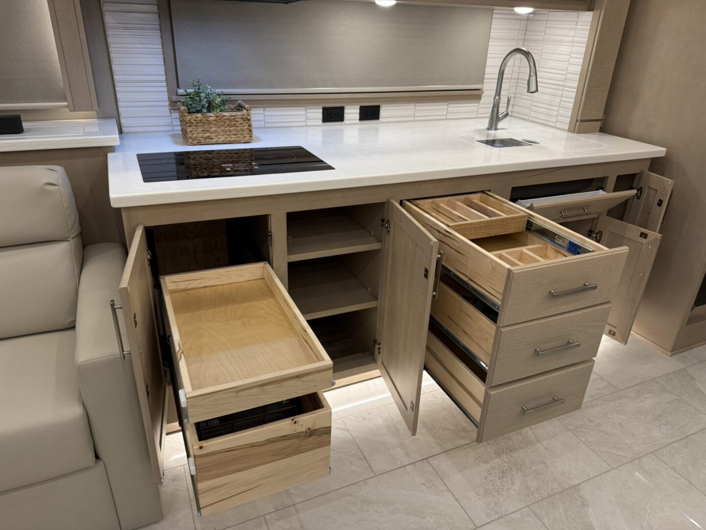 Modern kitchen with open drawers and cabinets.