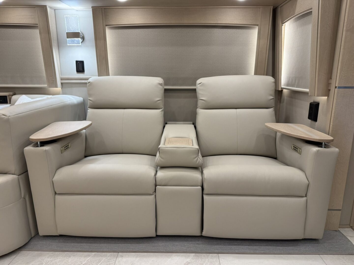 Comfortable beige reclining loveseat with armrests.