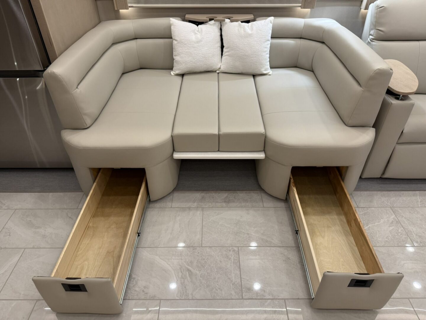 Modern beige sofa with storage drawers.