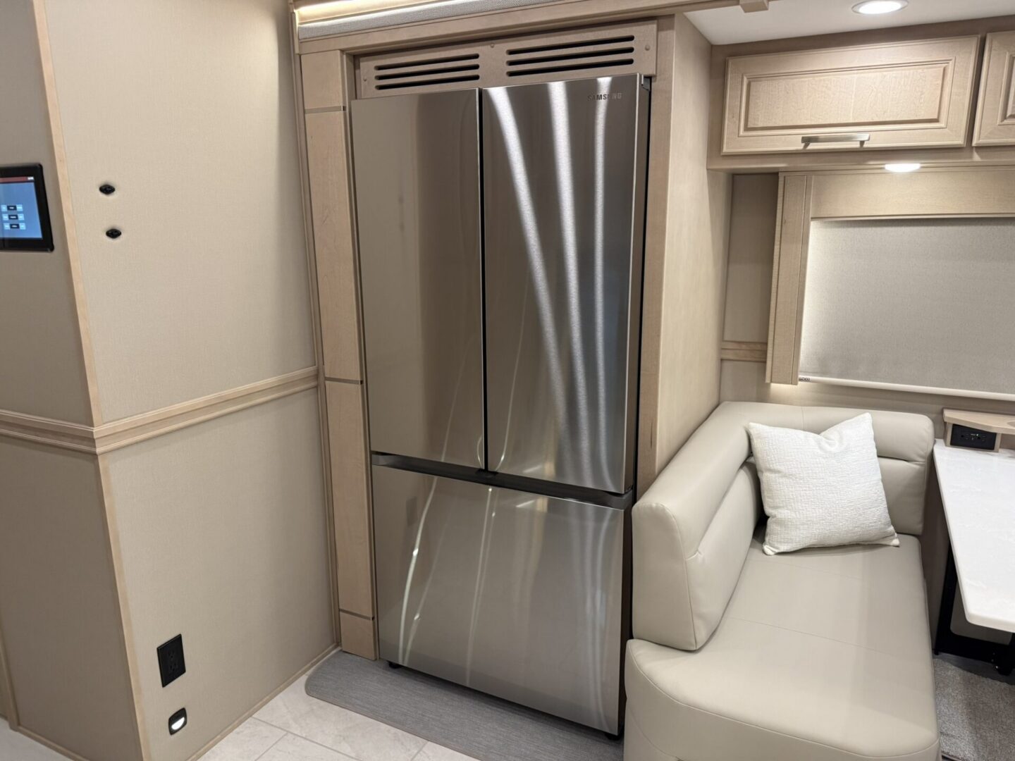 Modern kitchen with stainless steel refrigerator.
