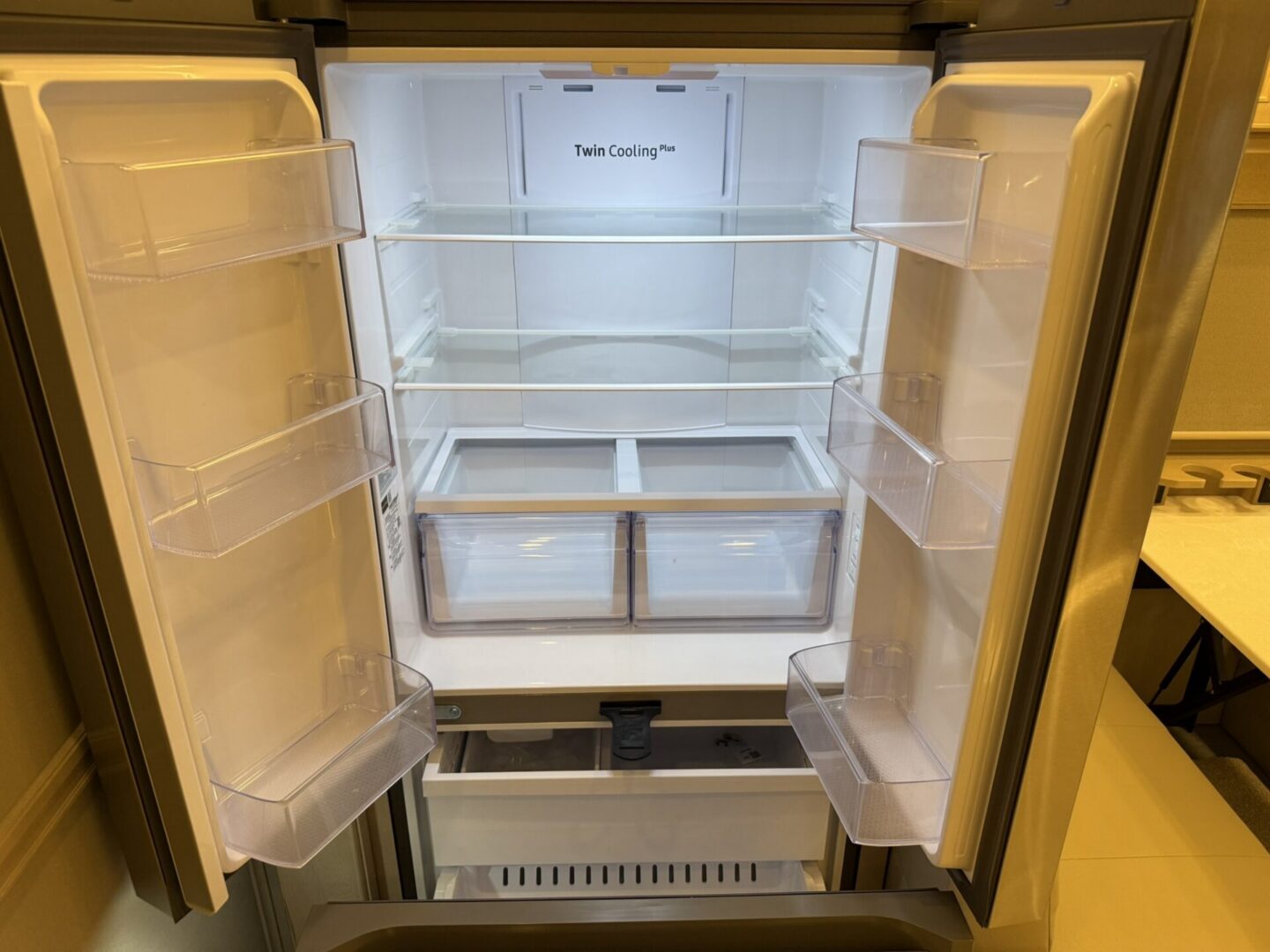 Empty refrigerator with bright interior lighting.