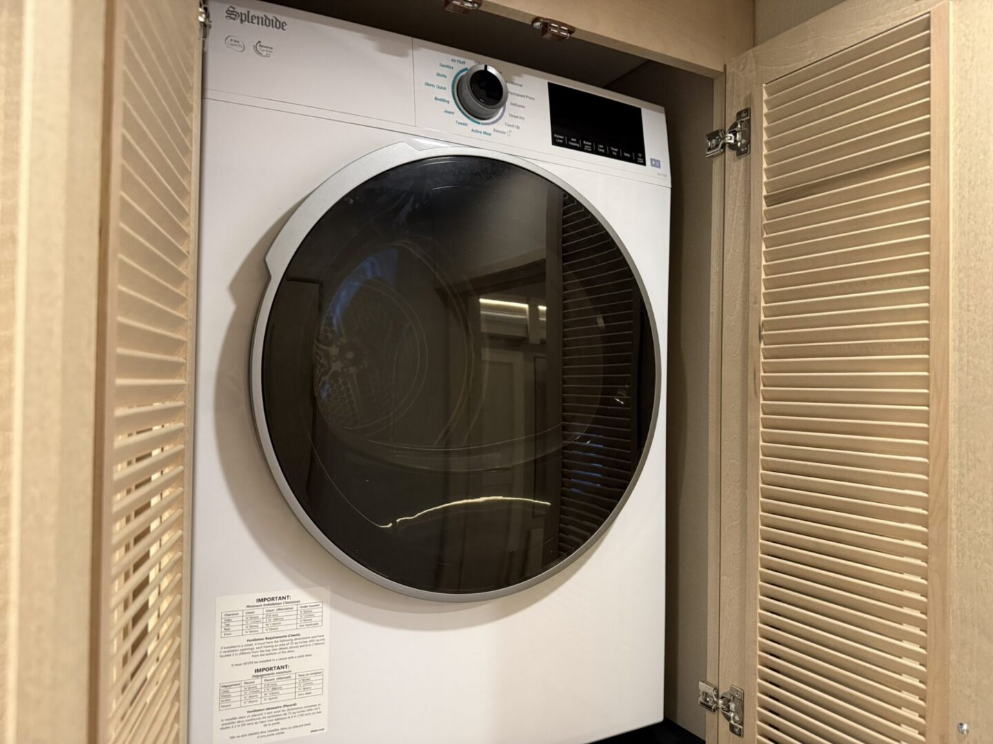 Washer dryer in a cabinet space.