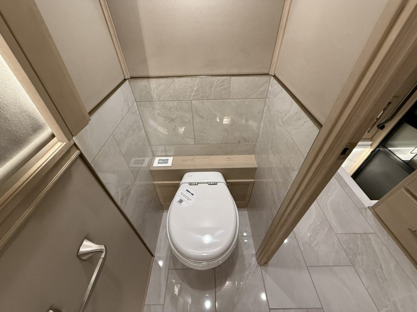 Modern bathroom with a toilet and tiles.