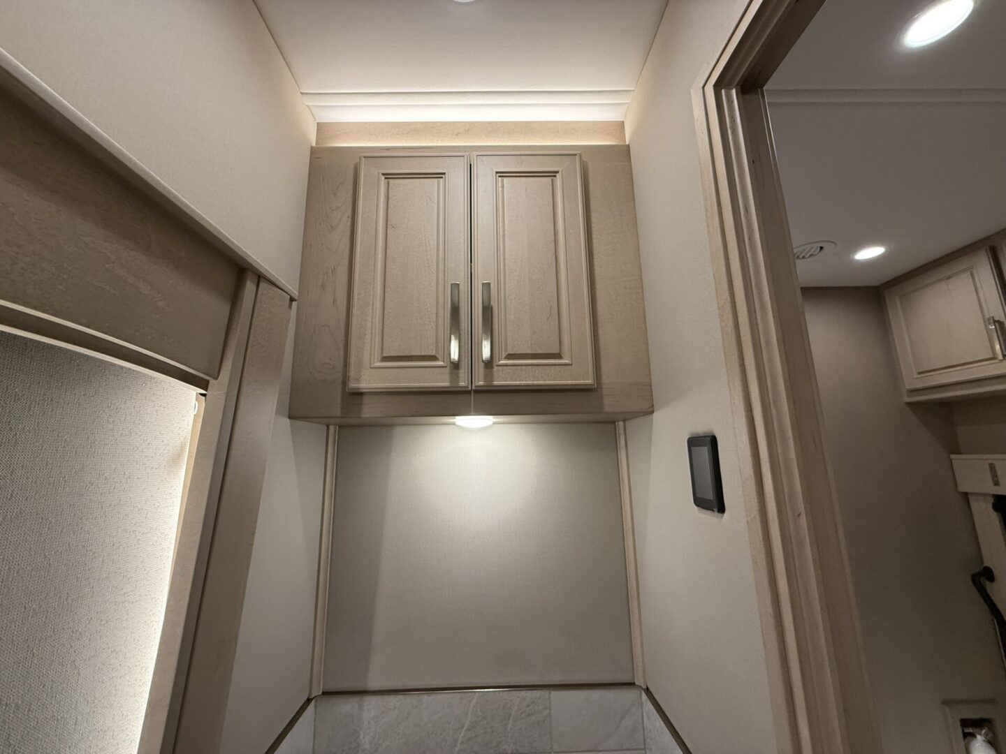 Modern kitchen cabinet with soft lighting.