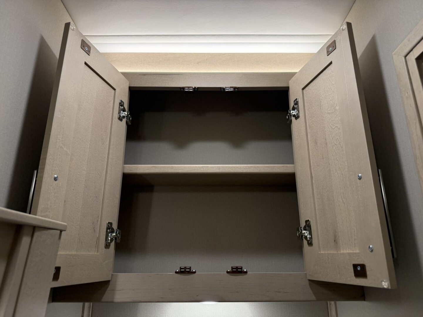 Open wooden cabinet with shelves inside.