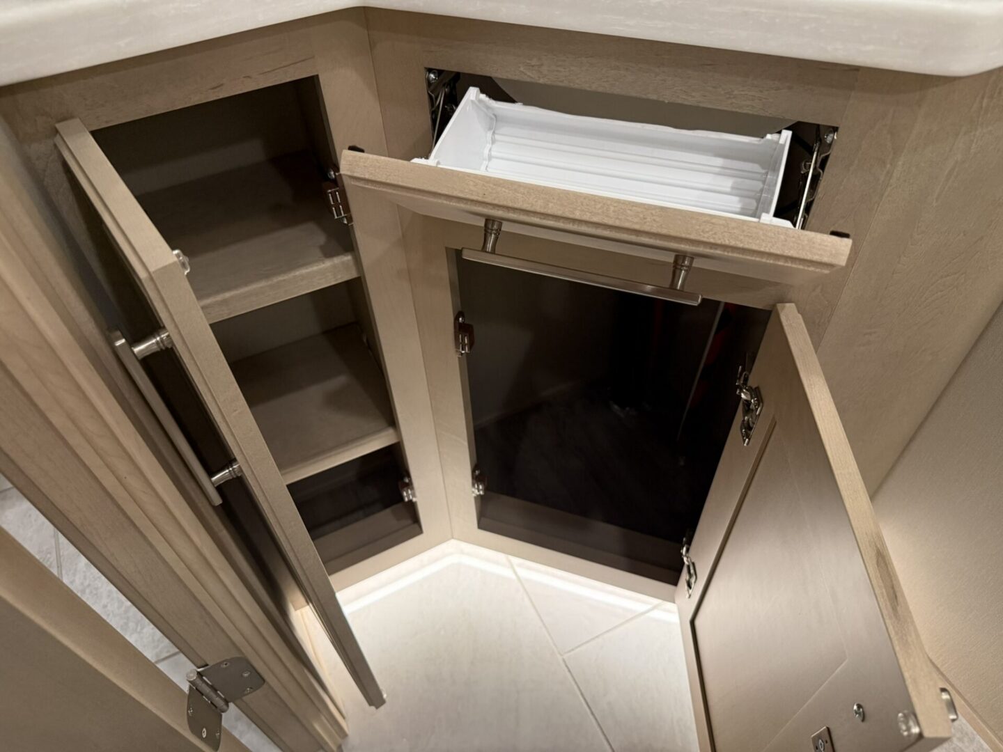 Storage cabinet with shelves and ice maker.