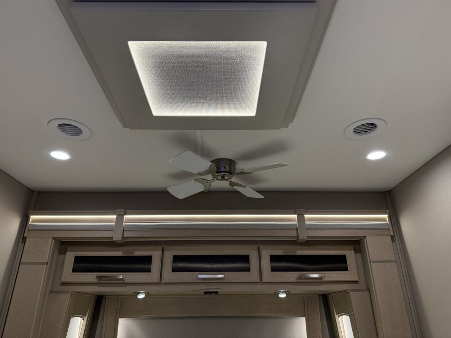 Modern ceiling with fan and recessed lighting.