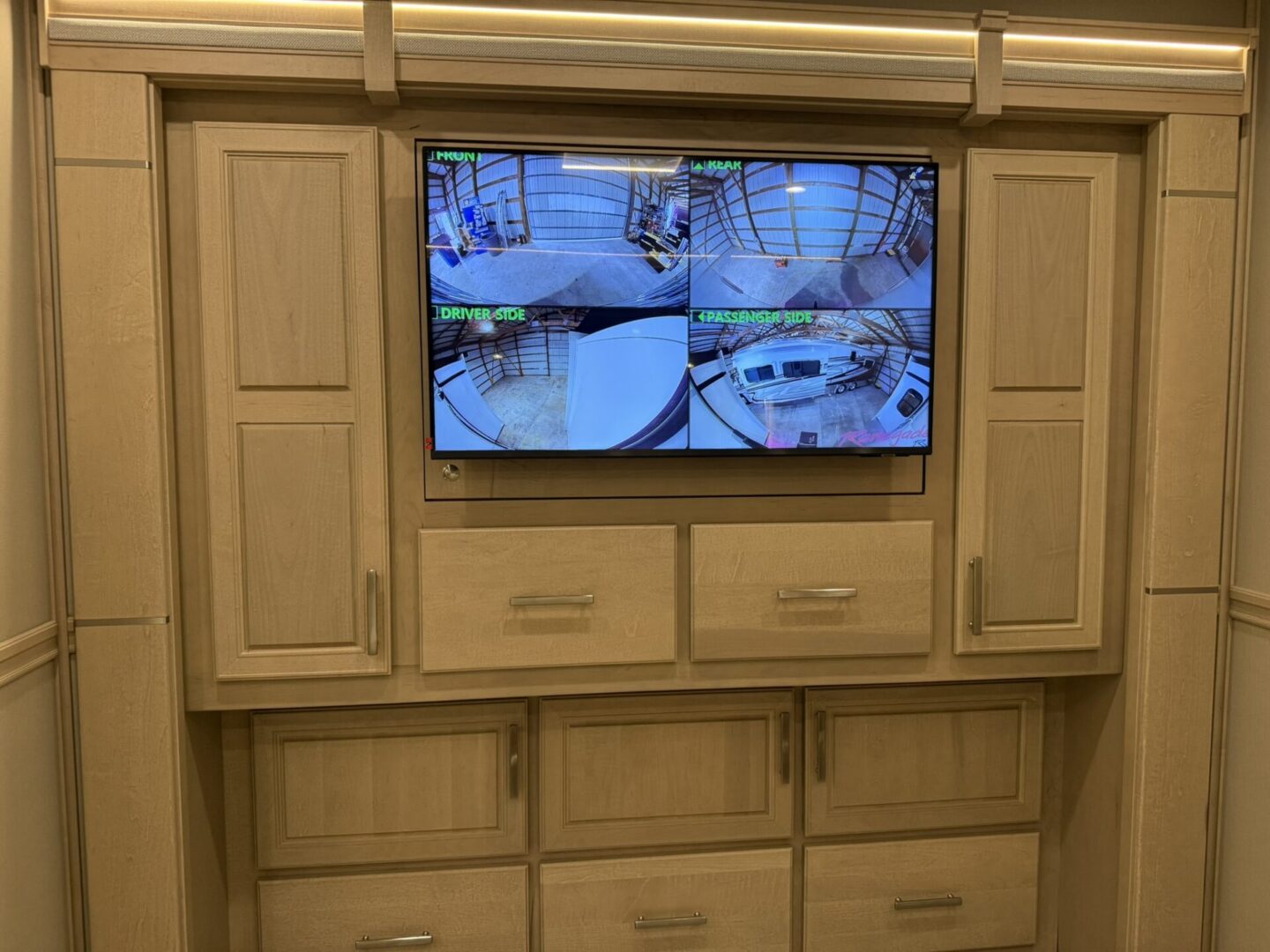 Surveillance camera display on wooden cabinet.