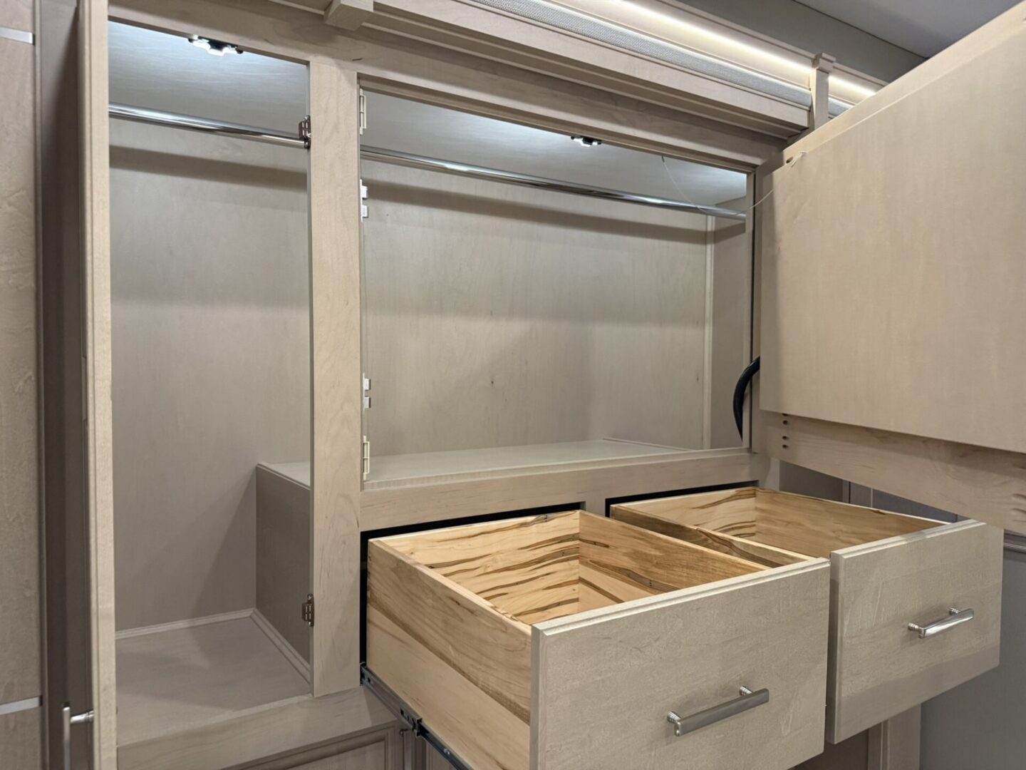 Modern kitchen cabinet with open drawers.