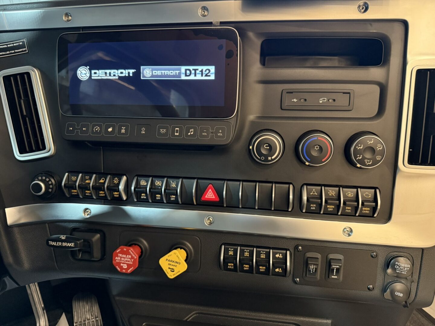 Truck dashboard with control panel and display.