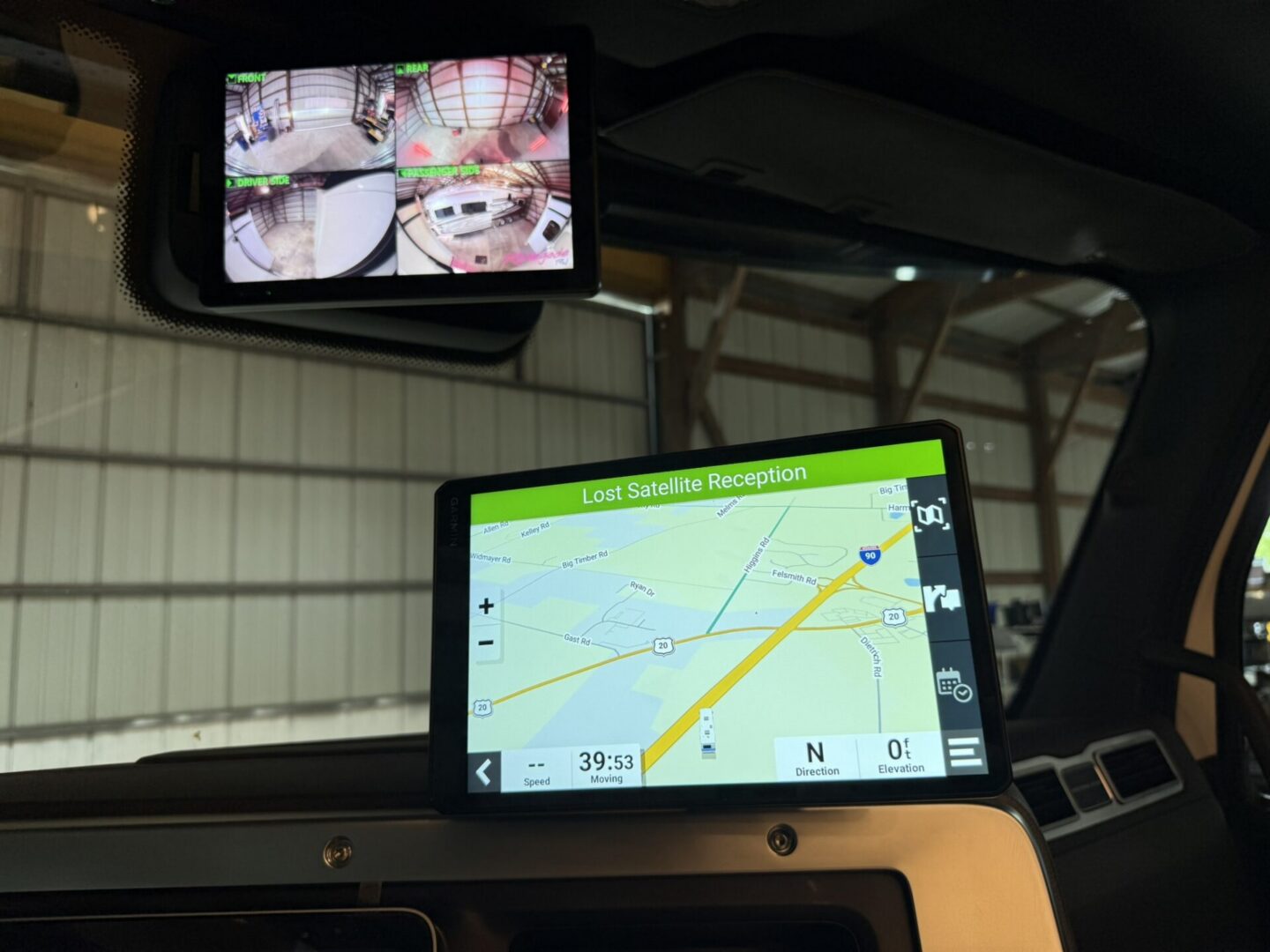 Car dashboard with navigation and camera displays.