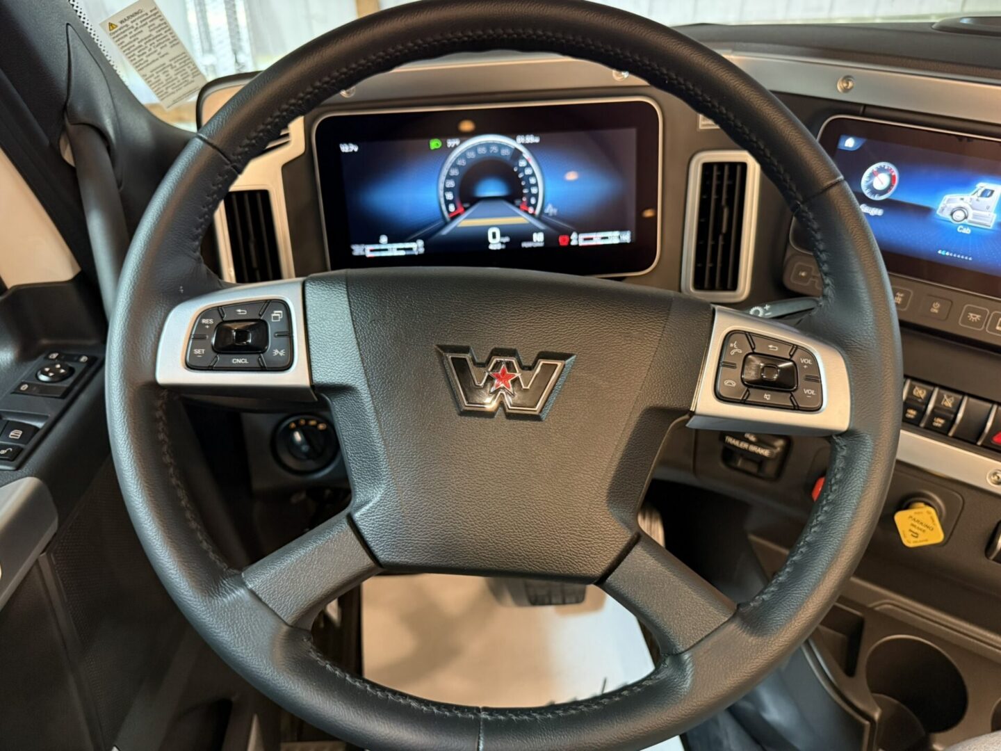 Truck steering wheel with dashboard display.