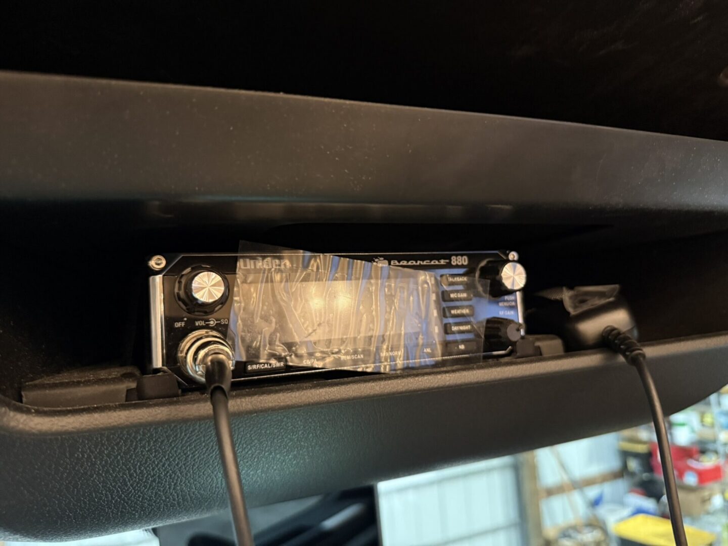 CB radio mounted in vehicle console.